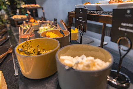 Luxurious Buffet with Ceramic Bowls and Garnished Plattersの写真素材