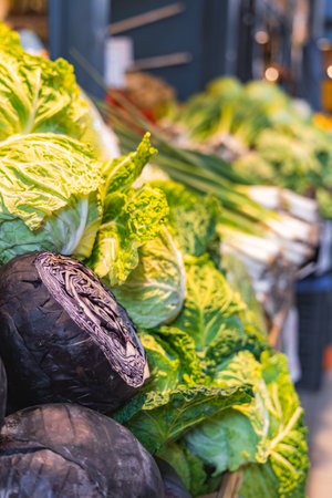Fresh Green and Purple Cabbages Displayed in a Market Settingの写真素材