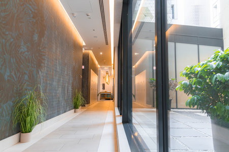 Modern Hotel Hallway with Ambient Lighting and Glass Windowsの写真素材
