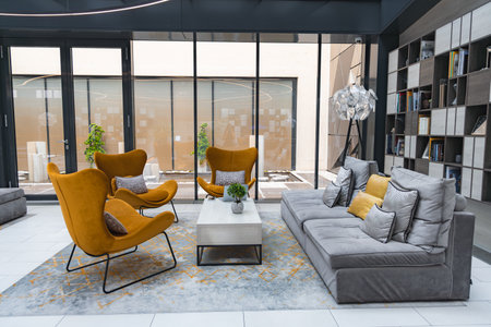 Modern Hotel Lounge with Mustard Armchairs and Floor to Ceiling Windows