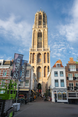 Dom Tower in Utrecht with Historic Buildings and Cobblestone Streetの写真素材