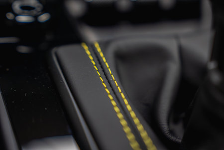 Close Up of Black Leather with Yellow Stitching in Luxury Car Interiorの写真素材