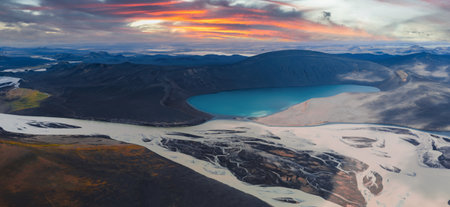 Aerial View of Volcanic Caldera with Turquoise Lake at Sunset in Icelandの写真素材