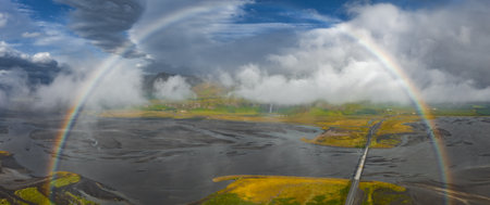 Aerial View of Icelandic Landscape with Double Rainbow and Braided Riverの写真素材