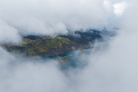Aerial View of Green Hills and Blue Lake with Islands in Iceland