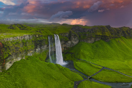 Seljalandsfoss Waterfall at Sunset with Vibrant Sky in Icelandの写真素材