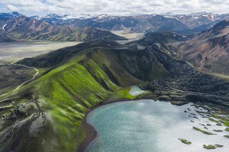 Aerial View of Green Mountain Landscape with Lake in Icelandの写真素材