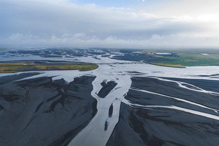 Aerial View of Braided River and Bridge in Icelands Volcanic Terrain