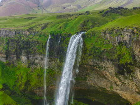 Seljalandsfoss Waterfall Cascading from Moss Covered Cliff in Icelandの写真素材