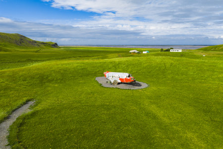 Decommissioned Red and White Aircraft on Gravel Patch in Icelandの写真素材