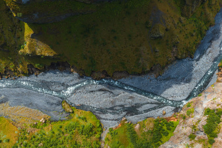 Aerial View of a Winding River in a Lush Green Canyon in Iceland
