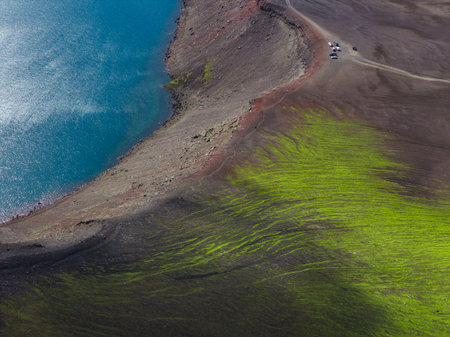 Aerial View of Turquoise Lake and Mossy Terrain in Iceland