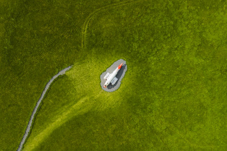 Aerial View of White Airplane Monument in Green Field in Iceland