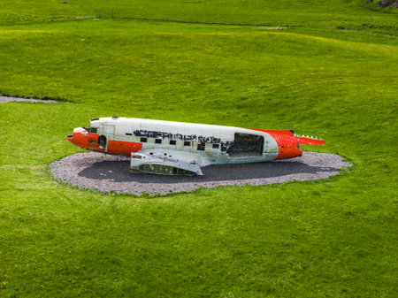Wreckage of White and Orange Aircraft on Gravel in Iceland