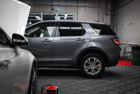 Gray Range Rover Discovery in Modern Car Shop Garage Interiorの写真素材