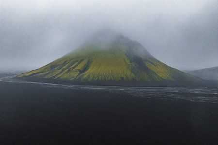 Misty Volcanic Mountain Covered in Green Moss in Iceland