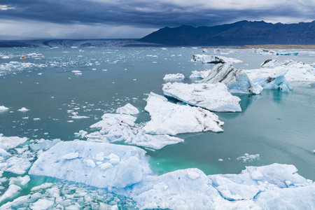 Aerial View of Glacial Lagoon with Icebergs and Mountains in Iceland