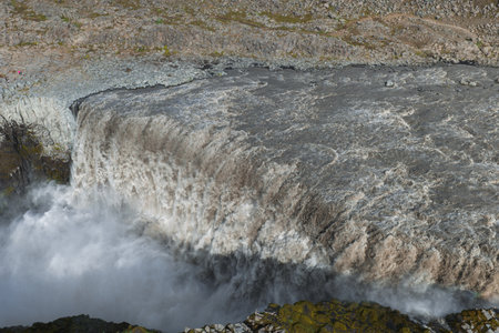 Aerial View of Dettifoss Waterfall and Rugged Terrain in Icelandの写真素材