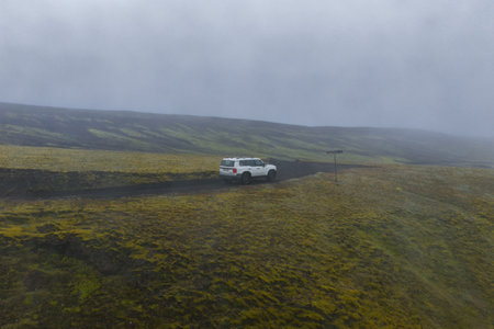 White SUV on a Dirt Road in Icelands Moss Covered Volcanic Terrain