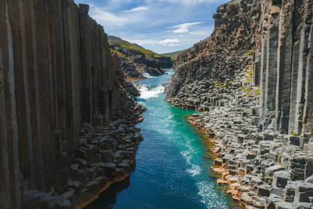 Aerial View of Studlagil Canyon with Basalt Columns and Turquoise River