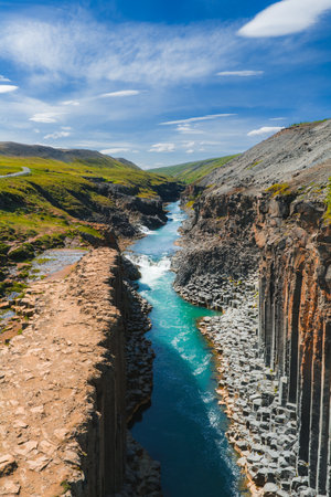 Aerial View of Studlagil Canyon with Basalt Columns and Turquoise River