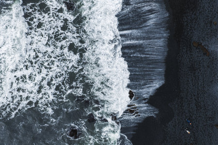 Aerial View of Ocean Waves Meeting Black Sand Beach in Iceland