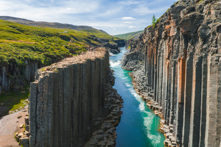 Aerial View of Studlagil Canyon with Basalt Columns and Turquoise River