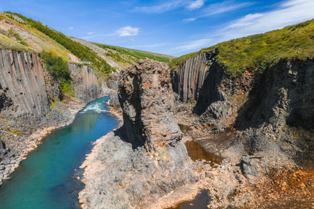 Aerial View of Studlagil Canyon with Basalt Columns and Turquoise River