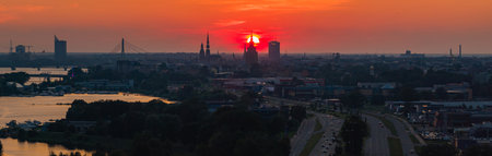 Sunset Over Riga with St. Peters Church and Daugava Riverの写真素材