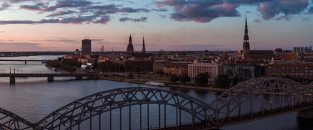 Sunset View of Riga Old Town and Railway Bridge Over Daugava River