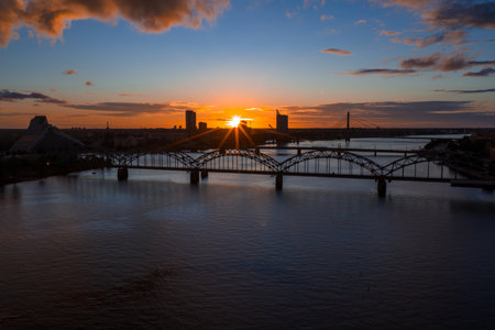 Sunset Over Riga with Railway Bridge and National Libraryの写真素材