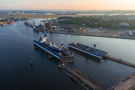 Shipyard with Docked Vessels and Cranes at Sunset in Riga, Latvia