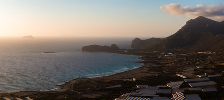 Aerial View of Coastal Bay and Greenhouses on Crete Island at Sunset