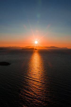 Sunset Over the Sea Near Crete Island with Silhouetted Mountains