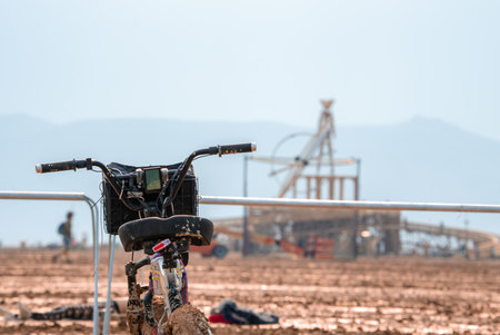 Muddy Bicycle and Wooden Art Installation at Burning Man Festivalの写真素材