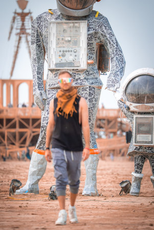 Person Walking Near Astronaut Art Installationsの写真素材