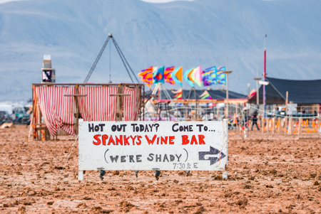Rain Soaked Desert Scene with Spankys Wine Bar Sign at Burning Manの写真素材