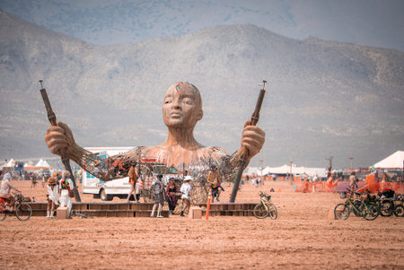 Large Human Sculpture with Rifles at Burning Man in Nevada Desertの写真素材