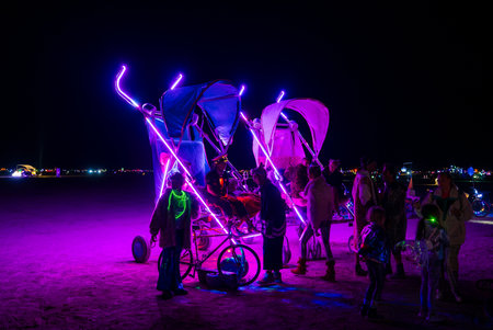 Illuminated Carriage Art Installation at Night in Burning Man