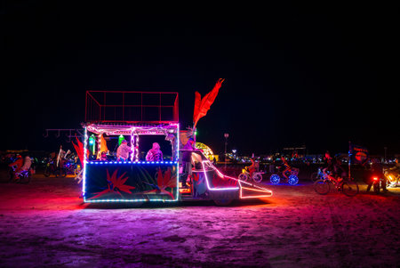 Illuminated Art Car with Neon Lights at Burning Man Festival at Night