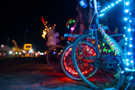Bicycles with Colorful LED Lights at Night in Burning Man Festivalの写真素材