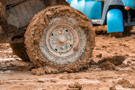 Mud Covered Vehicle Wheel and Wet Terrainの写真素材