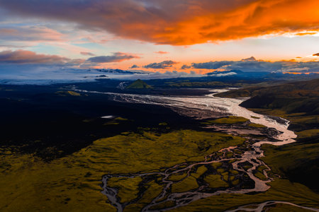 Aerial View of Icelandic Rivers, Glacier, and Volcanic Terrain at Sunsetの写真素材