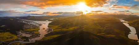 Aerial View of Icelandic River, Glacier, and Volcanic Crater at Sunsetの写真素材