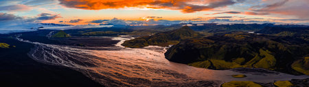 Aerial view of glacial rivers winding through a volcanic landscape in Iceland. Features include a...