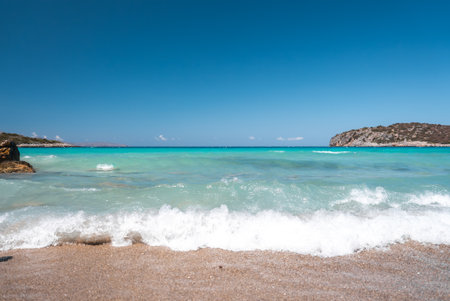 Serene Beach with Turquoise Water and Rocky Hill in Crete, Greeceの写真素材