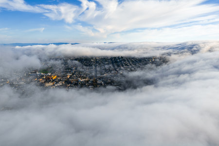 Aerial View of San Francisco with Fog and Sunlit Urban Landscapeの写真素材
