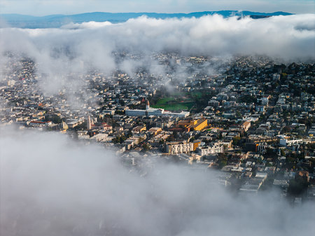 Aerial View of San Francisco with Fog, Urban Area, and Green Parkの写真素材