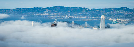 Aerial View of San Francisco with Fog, Bay Bridge, and Landmarks