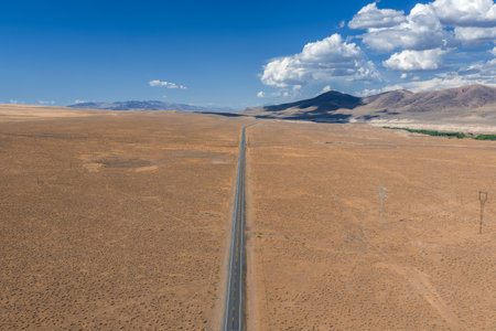 Aerial View of Desert Road and Rugged Hills in Nevada